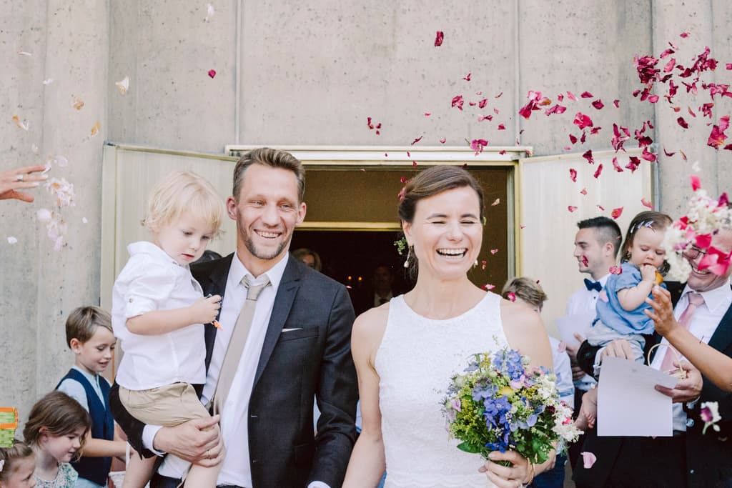 Bride and groom being received by their guests at Evangelische Kaiser-Friedrich Gedächtnis Kirche in Tiergarten in Berlin