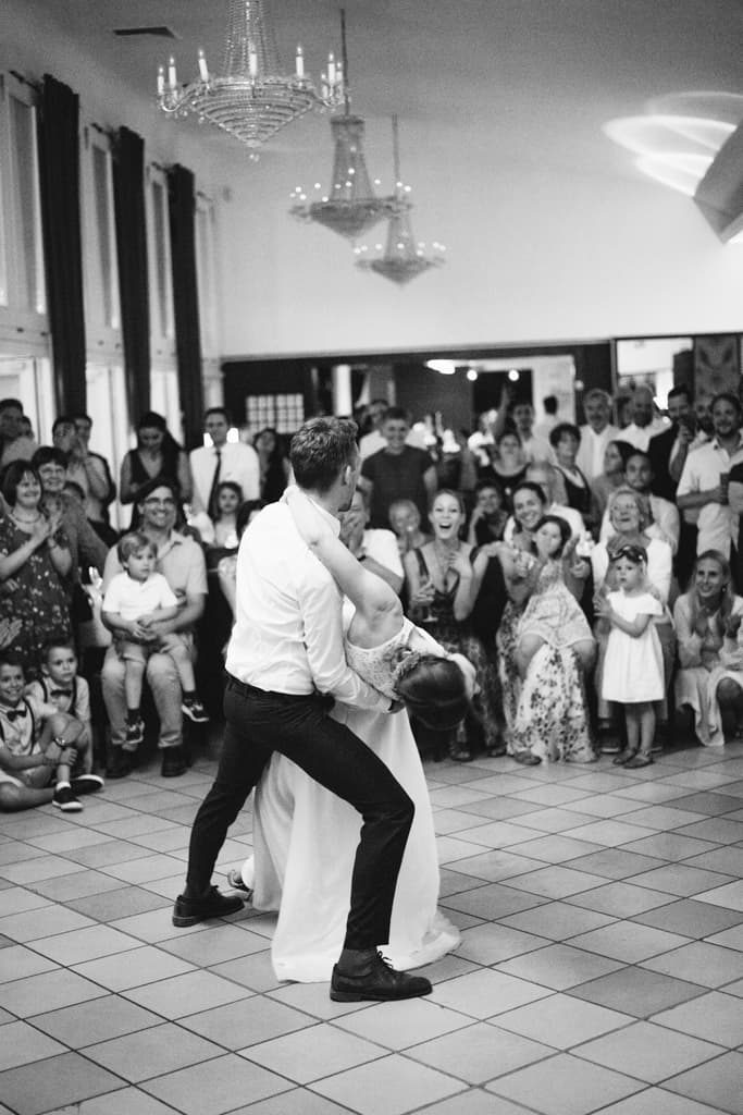 wedding couple dancing in front of their guests in the ballroom of the Teehaus in Englischer Garten in Berlin