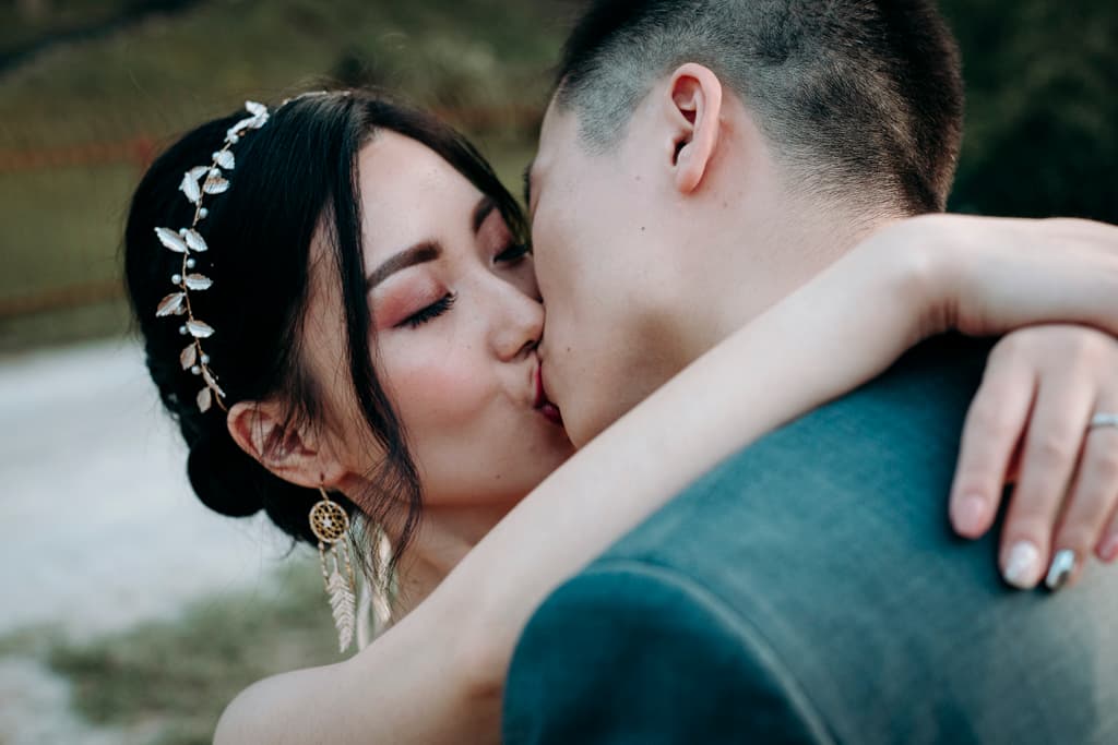 bride and grrom passionately kissing at lake bled