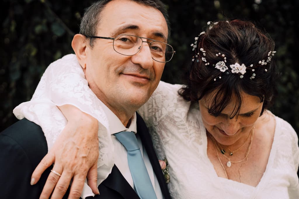 close up portrait of a wedding couple with the groom looking into the camera