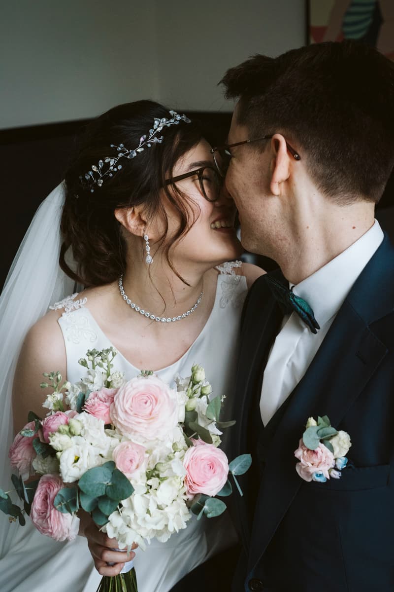 The couple has a romantic moment after the wedding ceremony in their room at Gästehaus Blumenfisch in Berlin Wannsee
